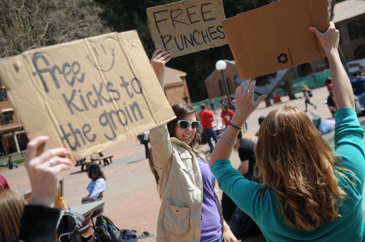 Western sophomores Rachel Plager, left, Cami Krema and Katie Osman hold up signs as a part of a "What would you do if?" experiment they created together, Wednesday, May 3 in Red Square. Photo by Daniel Berman/The A.S. Review